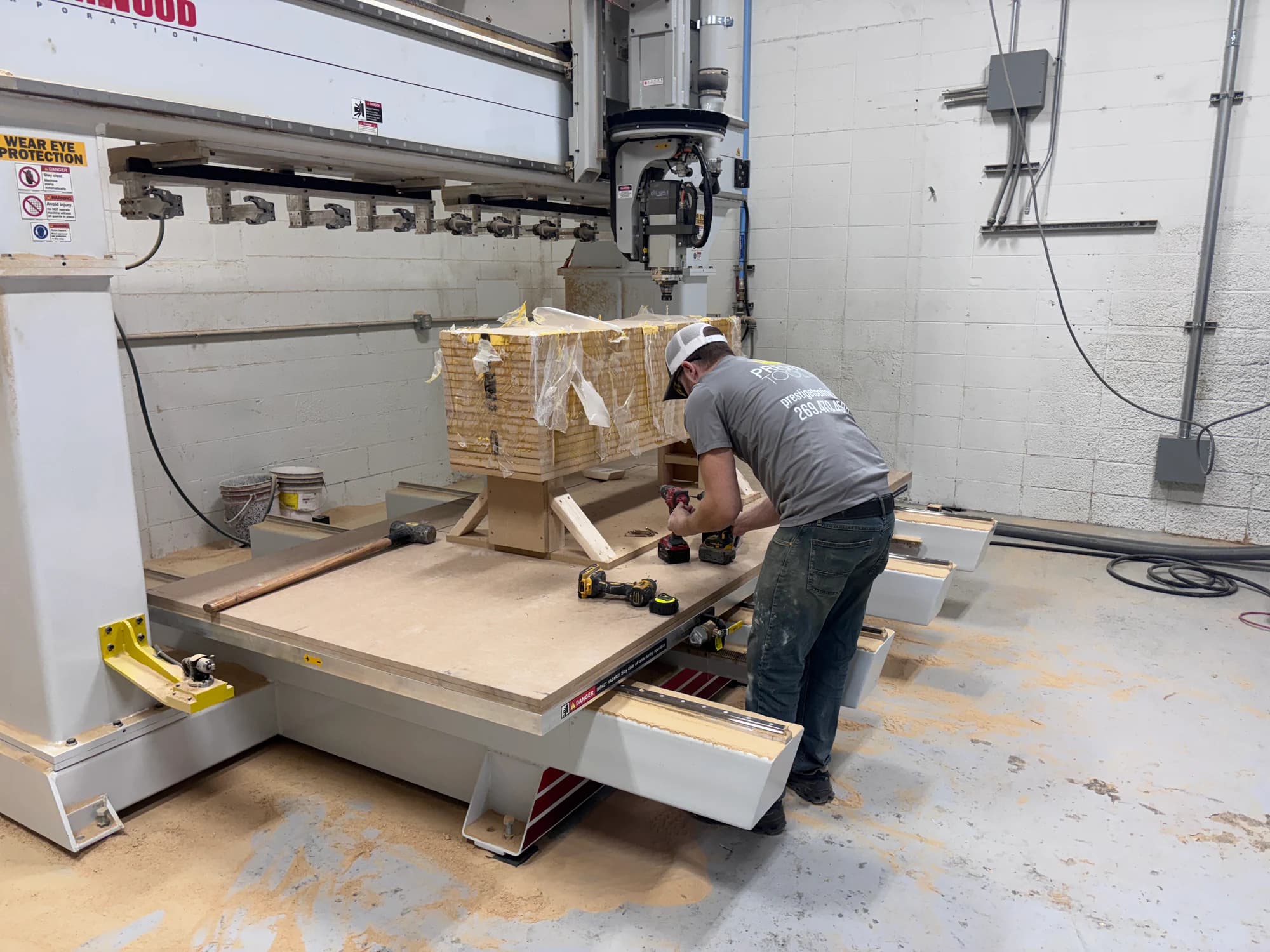Prestige technician preparing a laminated pattern blank on the Thermwood CNC router