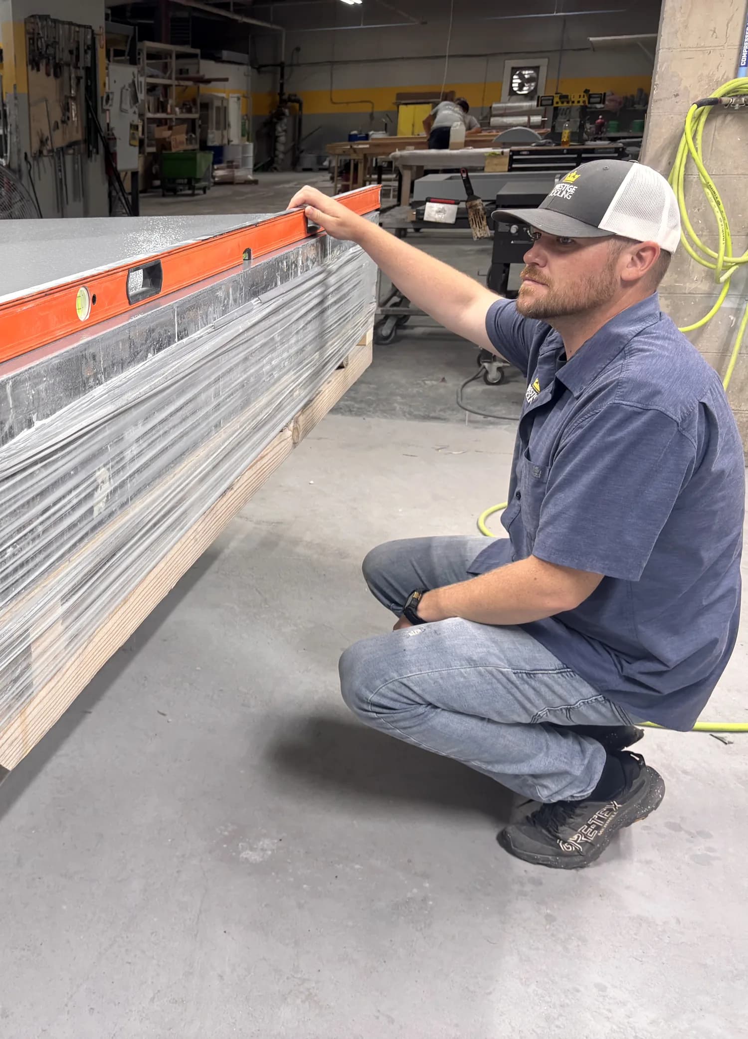 Dave checking a large tooling surface with a level in the Prestige shop