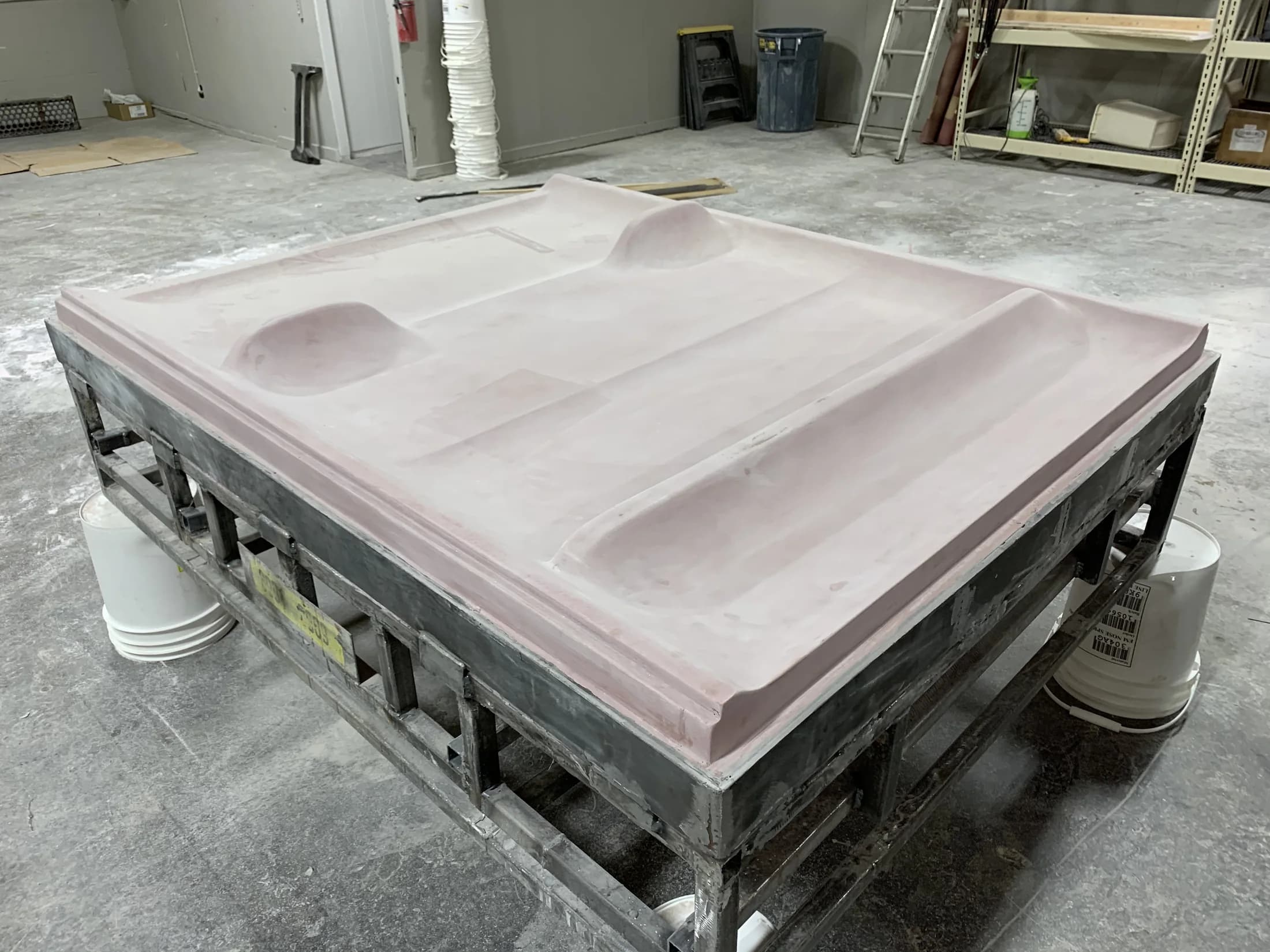 Completed thermoforming shower-wall surround mold on a support frame